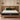 Front view of SpringFit Pocket Spring Premium Mattress on a brown leather platform bed in a warm-toned modern bedroom with pendant lighting